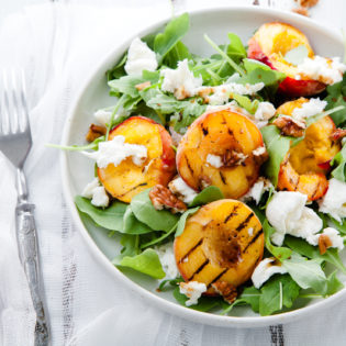 Grilled Stone Fruits with Baby Arugula, Toasted Pine Nuts, Roasted Garlic and Basil Vinaigrette